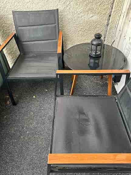 Cafeset två stolar, två-sits sofa med gråa dynor och runt bord svart