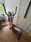 Cross trainer with a display and handles.