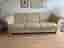 Beige 3-sits skinnsoffa med detaljer i ljus bok