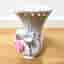 Vintage vase in the shape of a swan with a pink rose