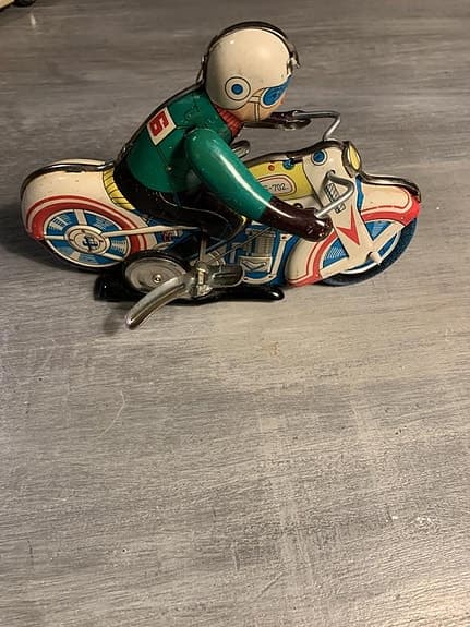 Leksaks motorcykel i plåt av äldre modell