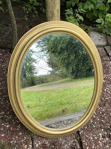 Oval spegel med tjock guldfärgad ram