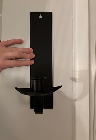 Svart vägghängd ljushållare