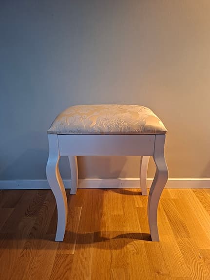 Vit pall med blommigt mönstrad dyna