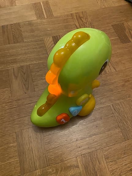 Bright Starts Rullande Dinosaurie – Rolig krypleksak med ljud & ljus