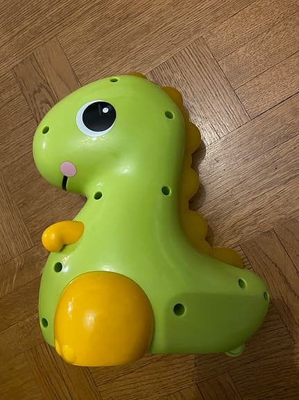 Bright Starts Rullande Dinosaurie – Rolig krypleksak med ljud & ljus