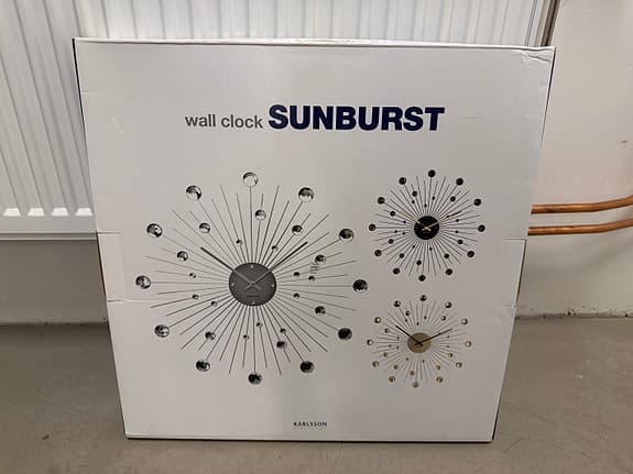 Karlsson väggklocka sunburst svart