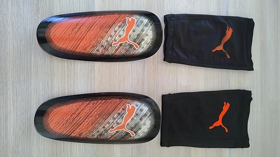 Puma benskydd fotboll orange svart för barn / junior