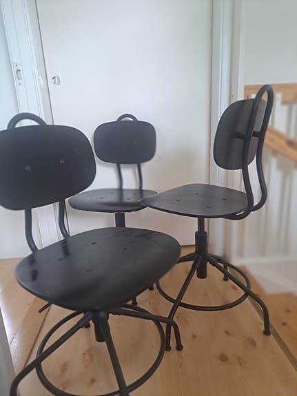 Tre svarta IKEA-industristolar med metallstativ