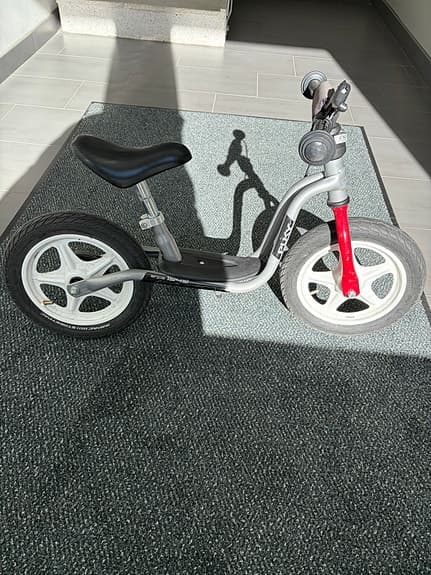 Balance bike with a scooter as an add-on