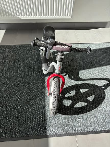 Balance bike with a scooter as an add-on