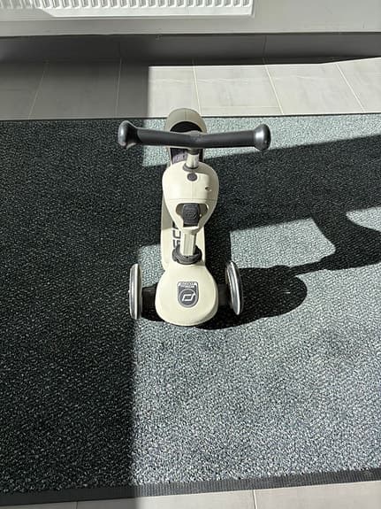 Balance bike with a scooter as an add-on