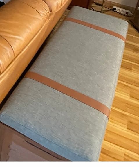 bänk med dyna i tyg och läderdetaljer