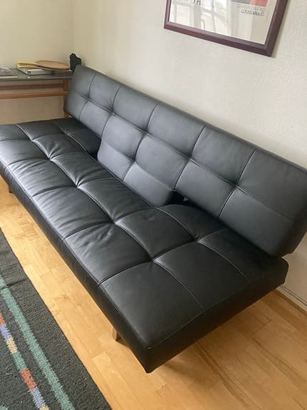 Designad bäddsoffa i svart konstläder 200x115 cm
