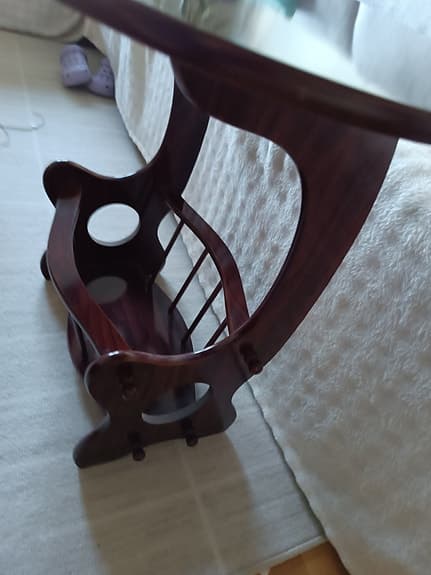 Ovalt tidningsbord i mörkt trä med tidningshylla