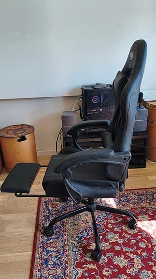 Svart gamingstol med fotstöd och armstöd
