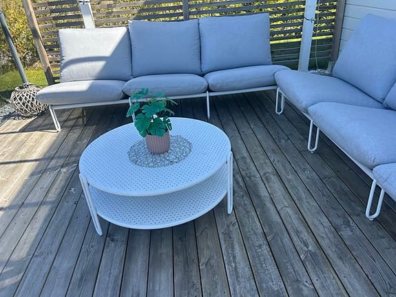 Ute loungesoffa med bord i vitt och grå dynor
