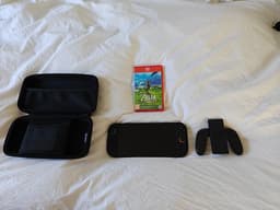 Nintendo Switch 2 spelkonsol med fodral och Mario Cart World och Zelda BOTW