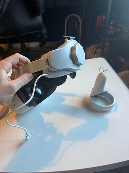 VR‑headset med handkontroller och extra batteri