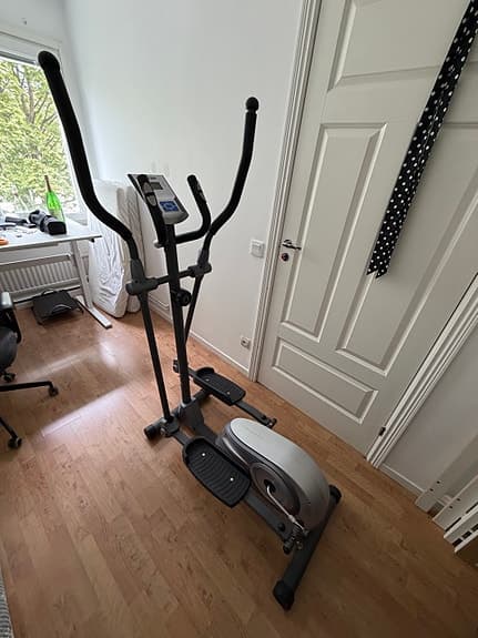 Cross trainer with a display and handles.