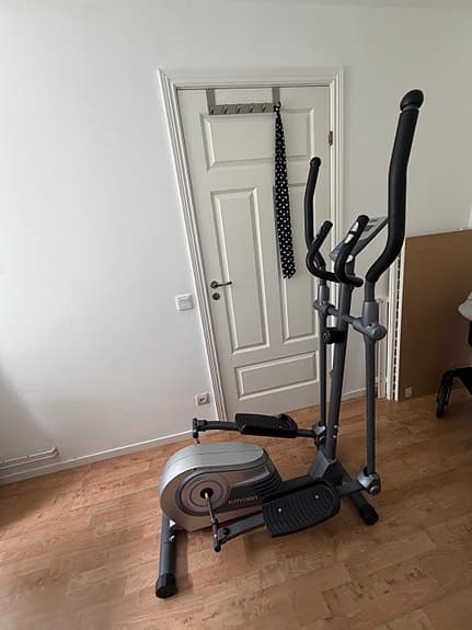 Cross trainer with a display and handles.