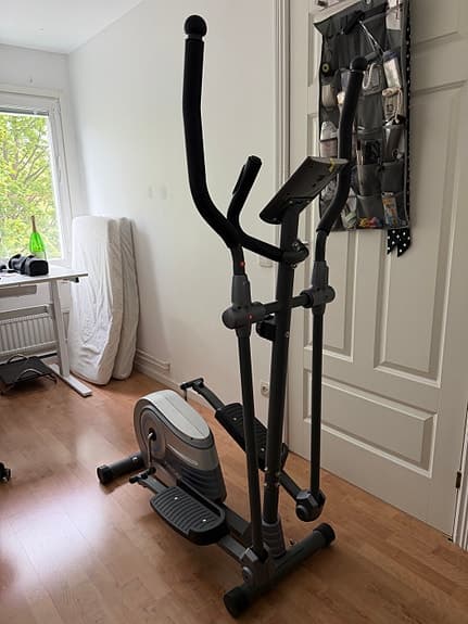 Cross trainer with a display and handles.