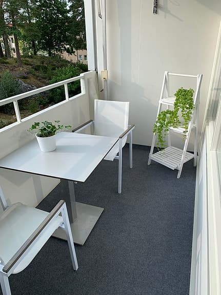 Vit balkonggrupp med bord och 2 stolar