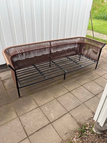 Brun utesoffa med svart metallstomme