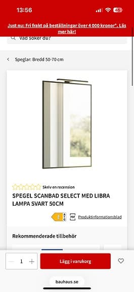 Badrumsspegel med svart ram och belysning