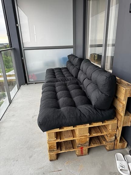 Balkongsoffa av lastpallar med tjocka dynor