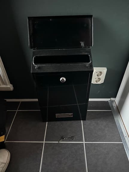 Svart postlåda med lås