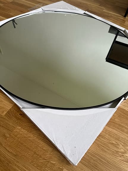 Runt väggspegel med tunn svart kant