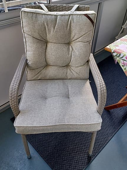 Stapelbar trädgårdsstol i konstrotting med dynor i beige