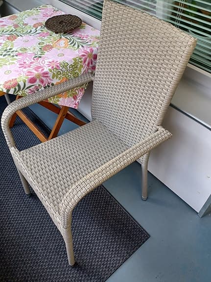 Stapelbar trädgårdsstol i konstrotting med dynor i beige