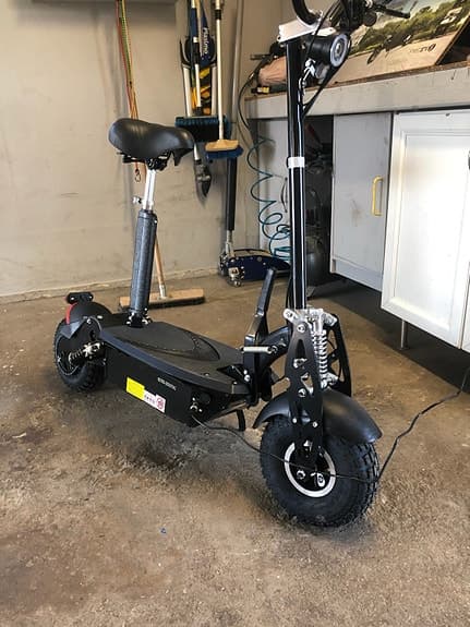 Svart el-scooter med sadel