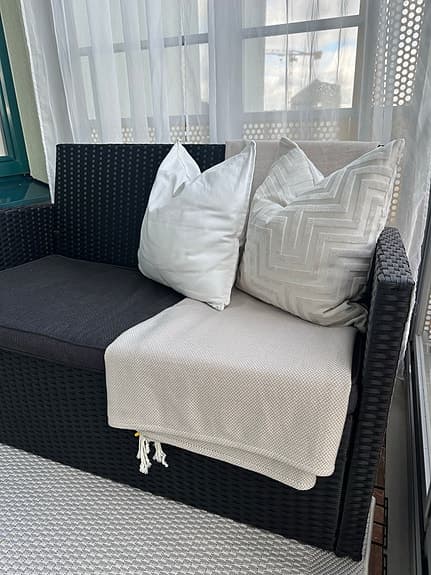 Ute-och balkongmöbler. Svart konstrotting soffa och fåtölj med grå dynor
