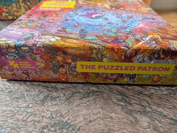 Magic Puzzle Company The Puzzled Patron pussel 1000 bitar