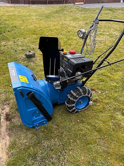 Blå snöslunga med bensinmotor