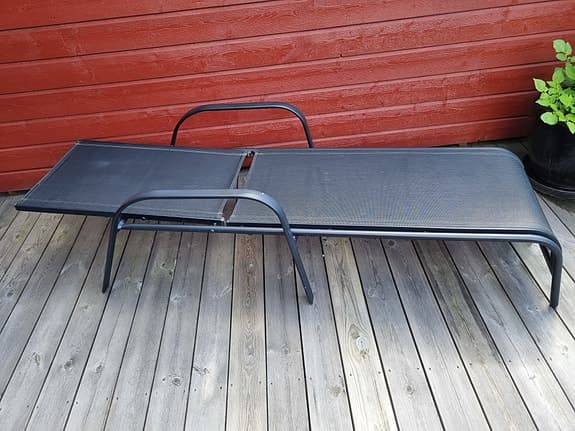 Svarta solsängar i metall med textilsits