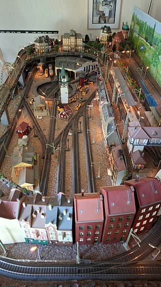 Modelltåg Märklin tågbana med landskap och hus