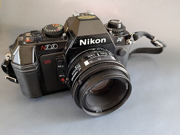 NIKON N2020(usa)/F501(eu) + 50mm 1.8 AF-Nikkor + MF-19 databack.