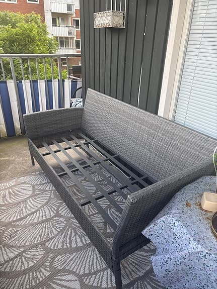 Grå utesoffa i konstrotting.
