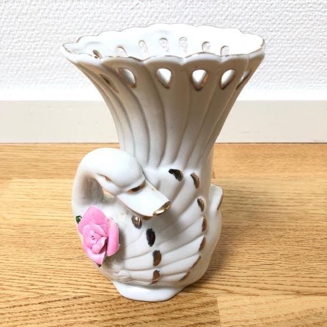 Vintage vase in the shape of a swan with a pink rose