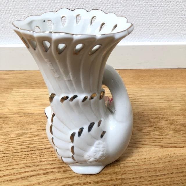 Vintage vase in the shape of a swan with a pink rose