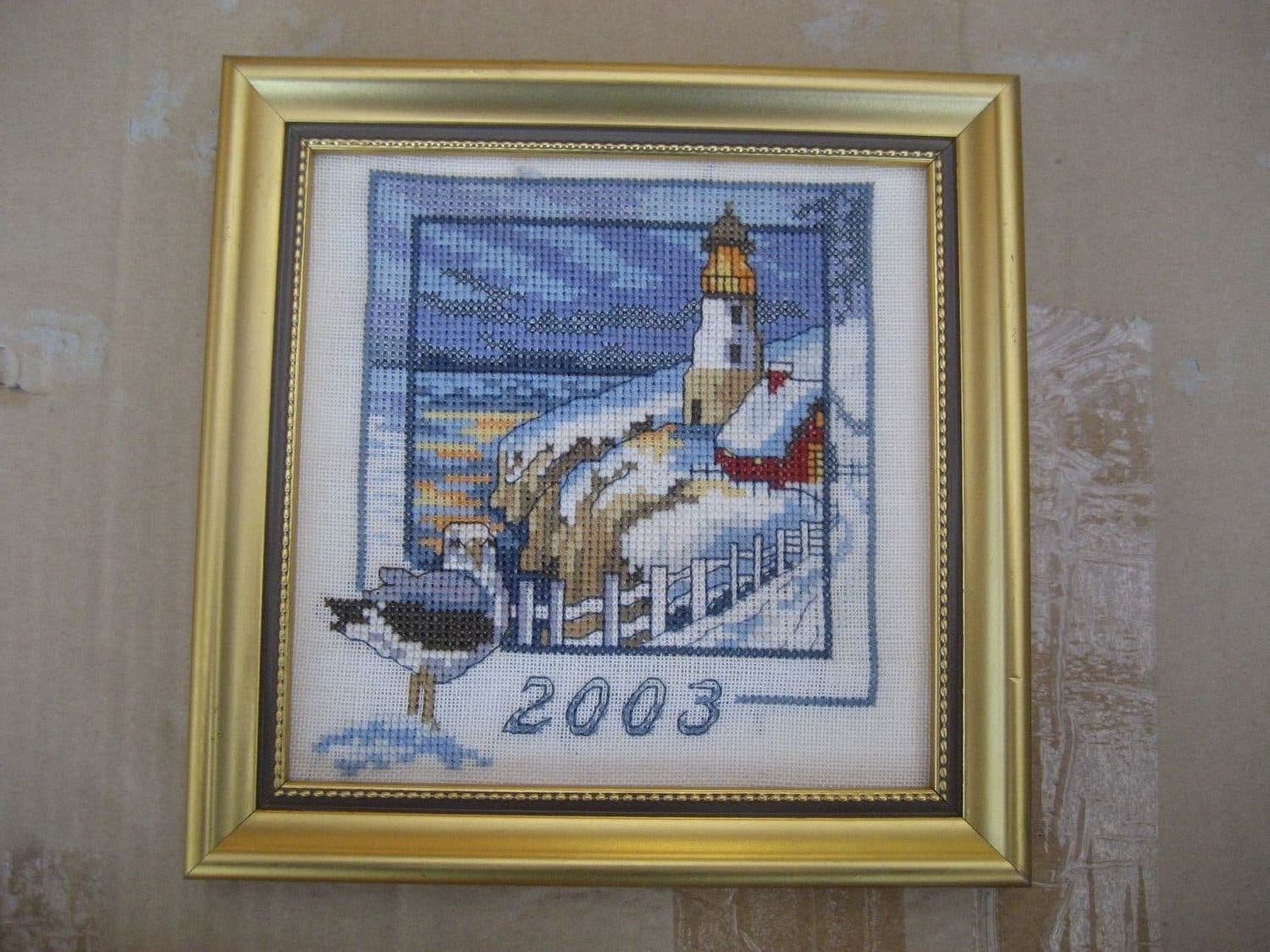 Tavla handsydd med motiv på hus & fyr i vinterlandskap - Årstavla 2003