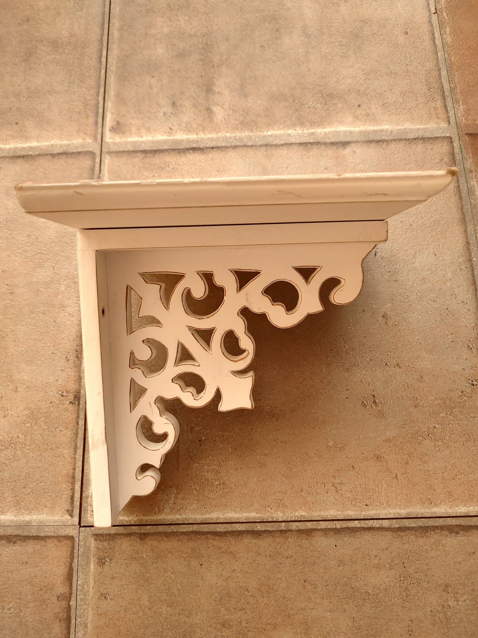 Vit hylla med snidade detaljer