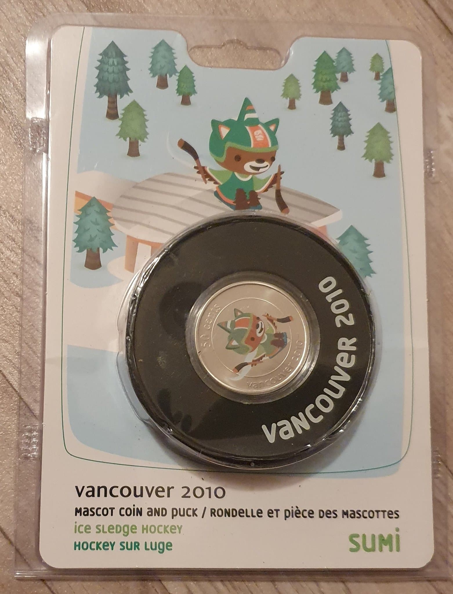 Ishockey Puck Olympic Games 2010 med Maskottchen