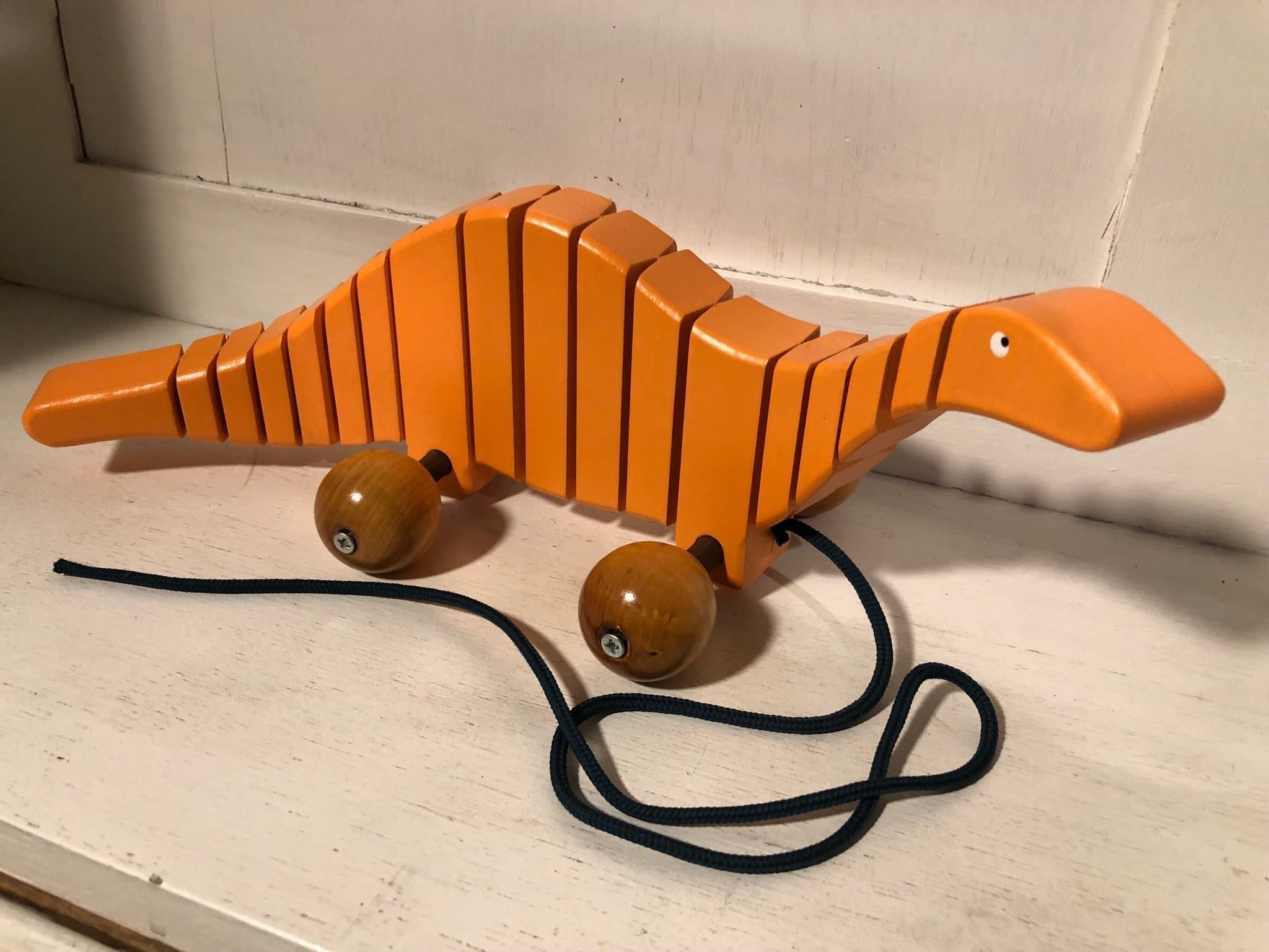 Trä dragleksak orange dinosaurie
