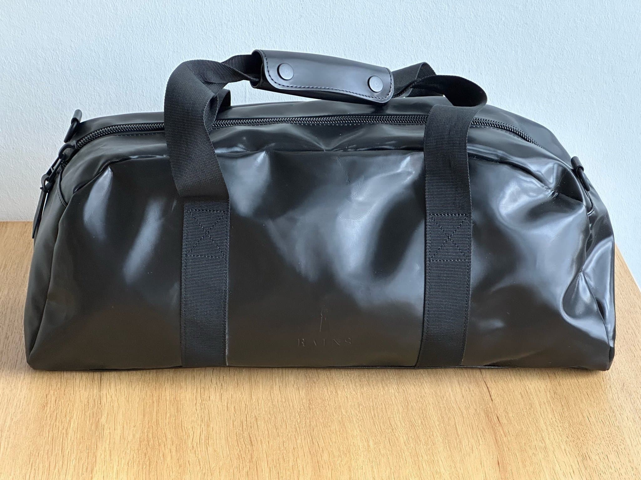 Rains shiny black small daily duffel bag