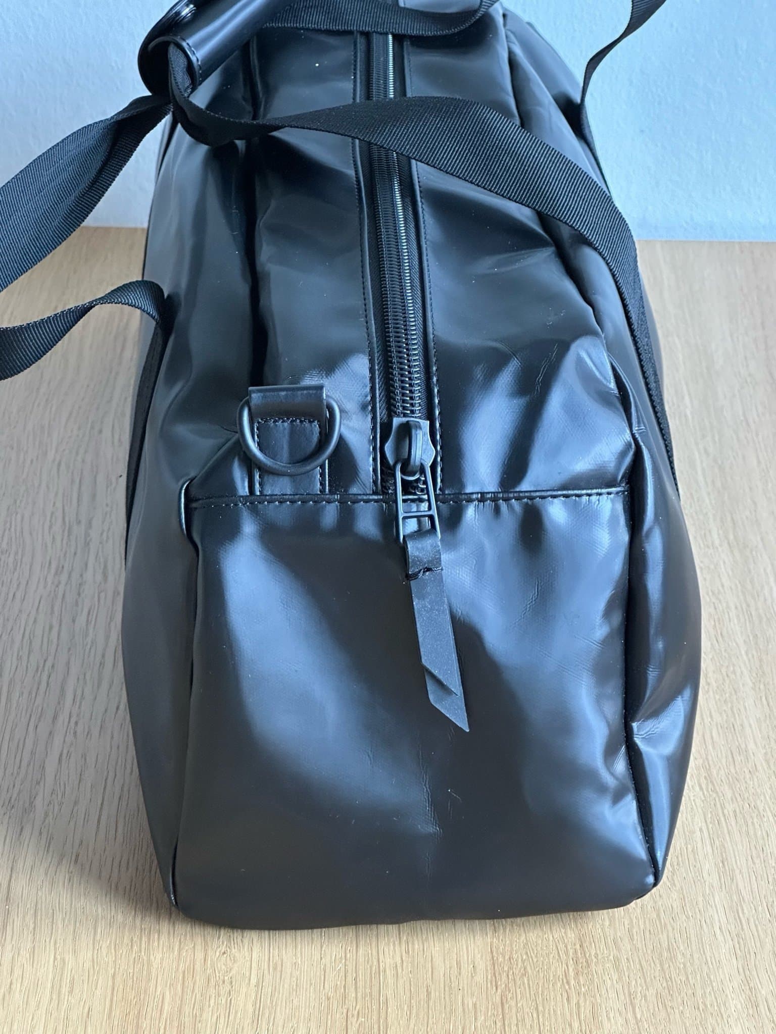 Rains shiny black small daily duffel bag